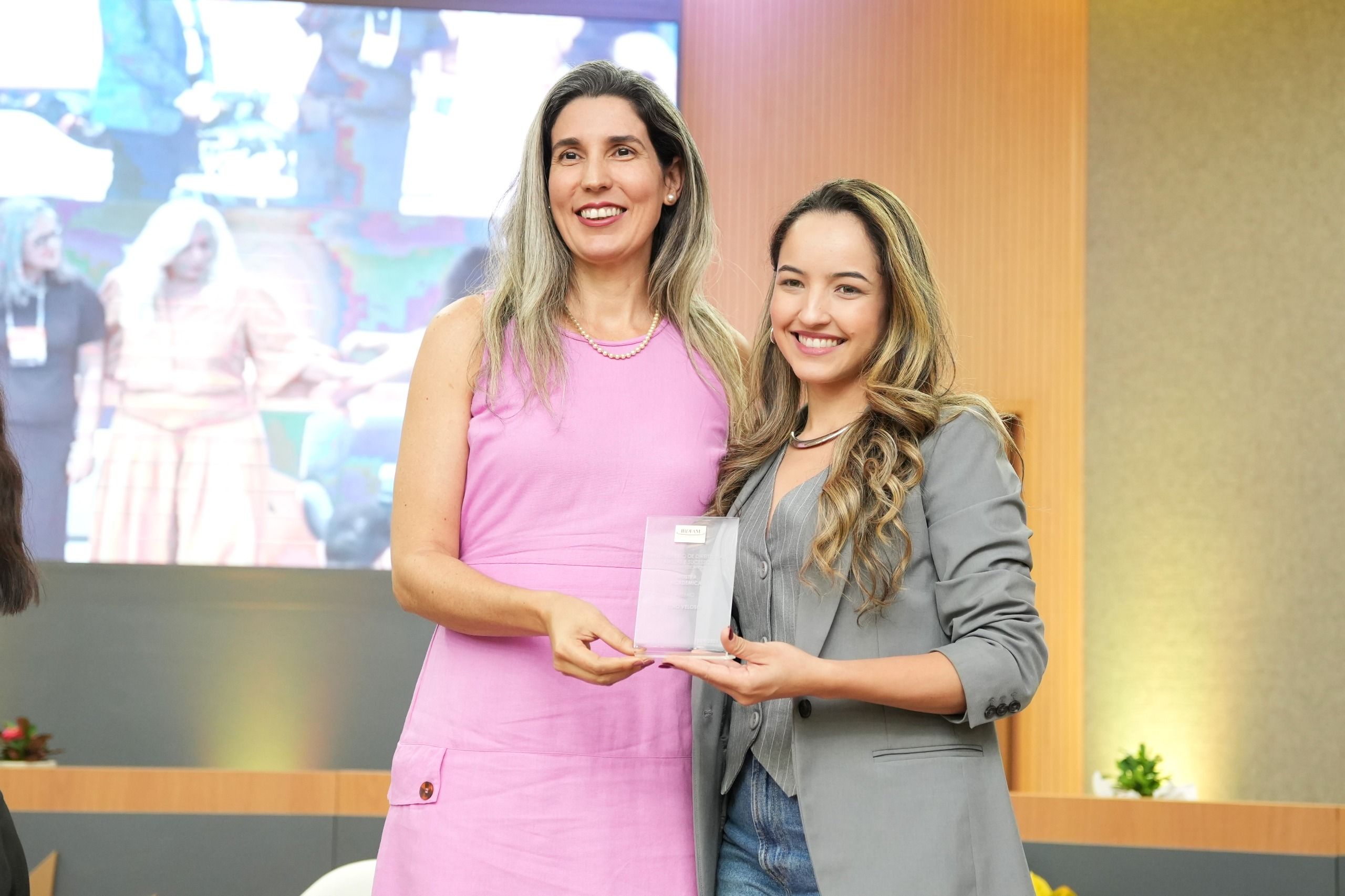 A defensora pública Elydia Leda Barros Monteiro compôs a banca avaliadora da da Mostra Acadêmica e entregou o Prêmio Zeno Veloso à acadêmica Juliana Rodrigues de Oliveira